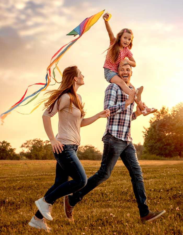 family on a walk with a kite