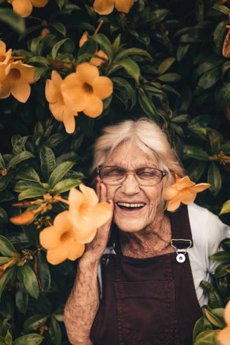 smiling elder lady with flowers
