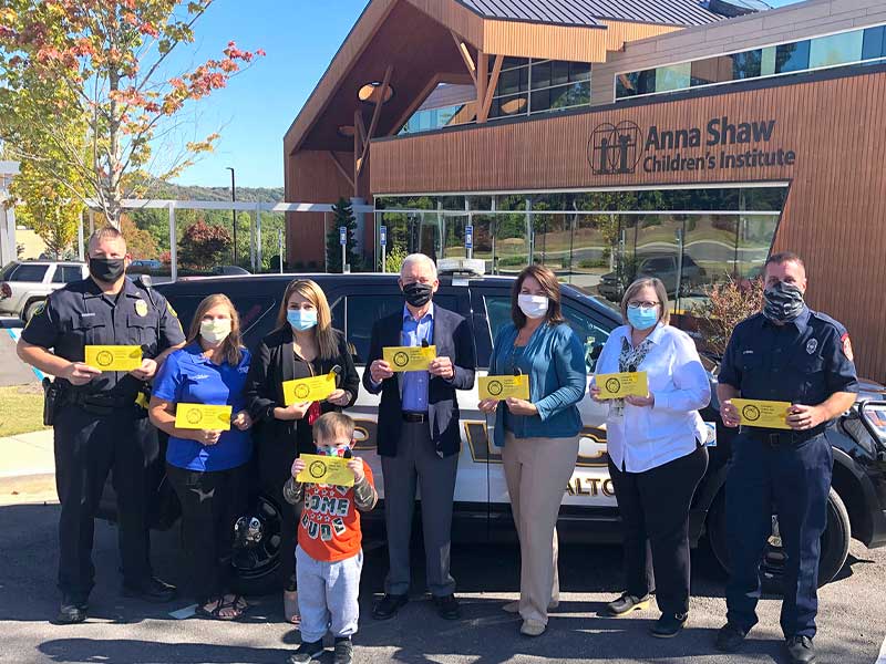 Hamilton Health Care System participating in  DPH Georgia Yellow Dot Program - first responders pose with staff and children