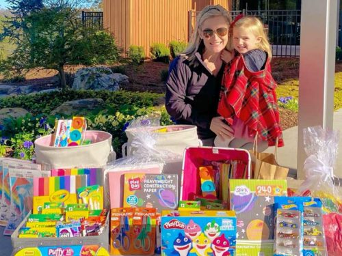 mom with daughter and donated toys