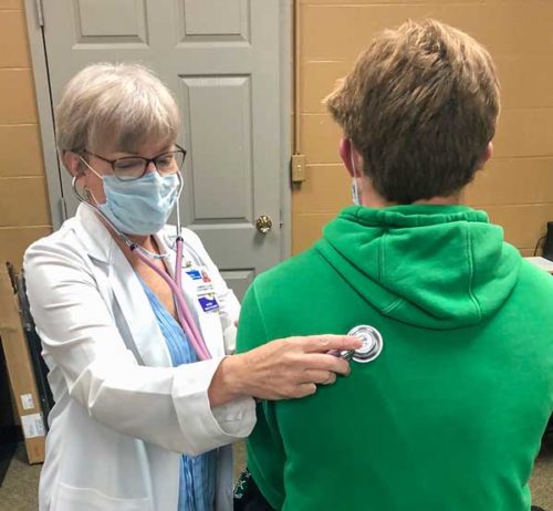 Nancy Giammarella, NP, checks the heart and lung function of a student athlete.