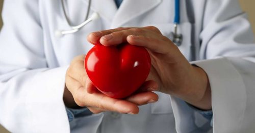 National Atrial Fibrillation (AFib) Awareness Month - doctor holding plastic heart