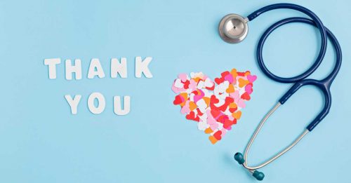 Thank you note with paper hearts and stethoscope