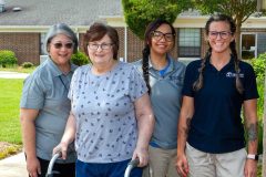 quinton rehab associates with patient in courtyard